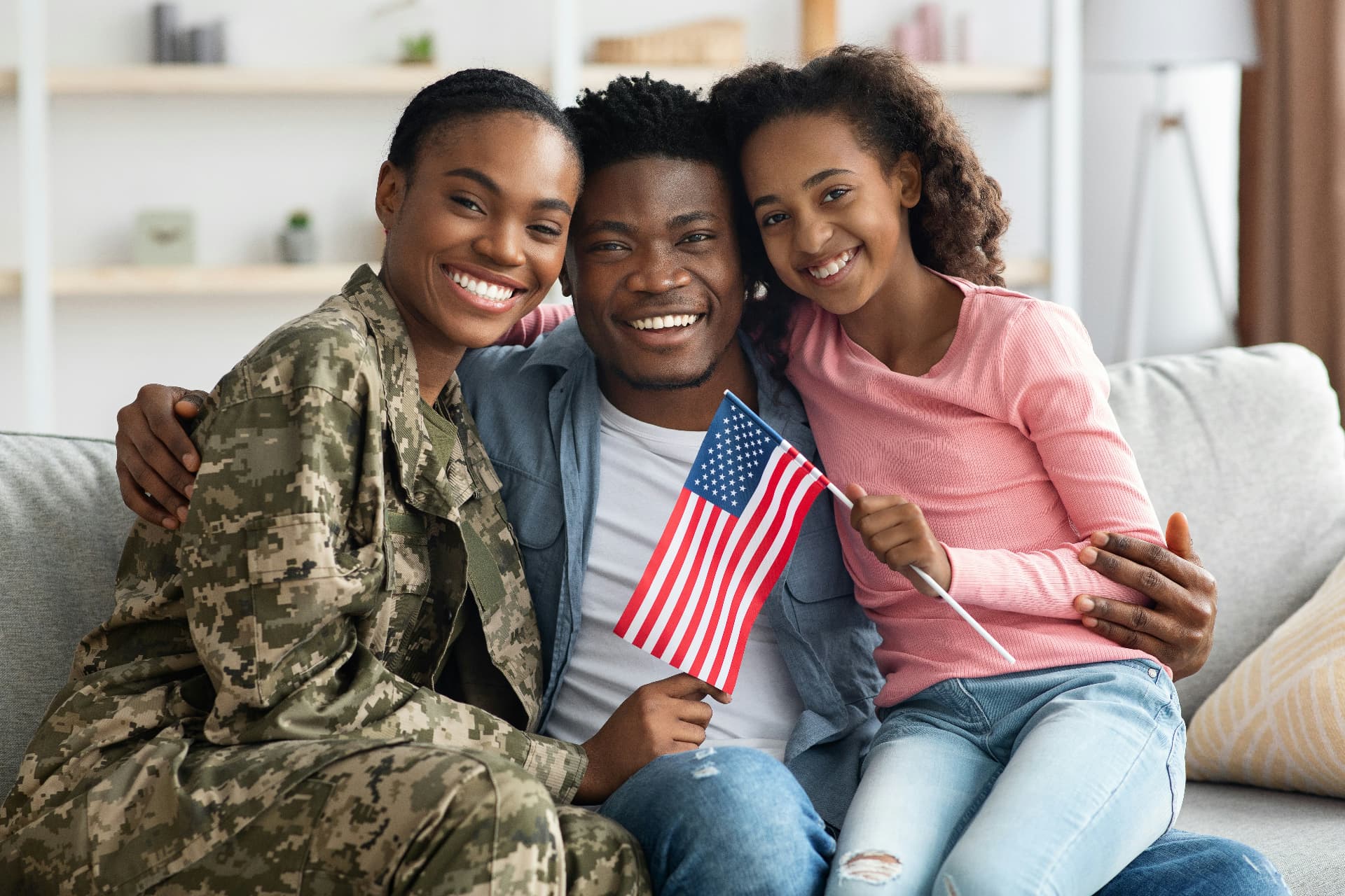 Military family relaxing together at home with their daughter